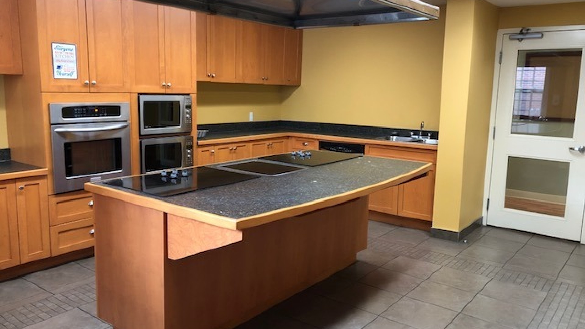 Governors Hall kitchen with ovens and an island.