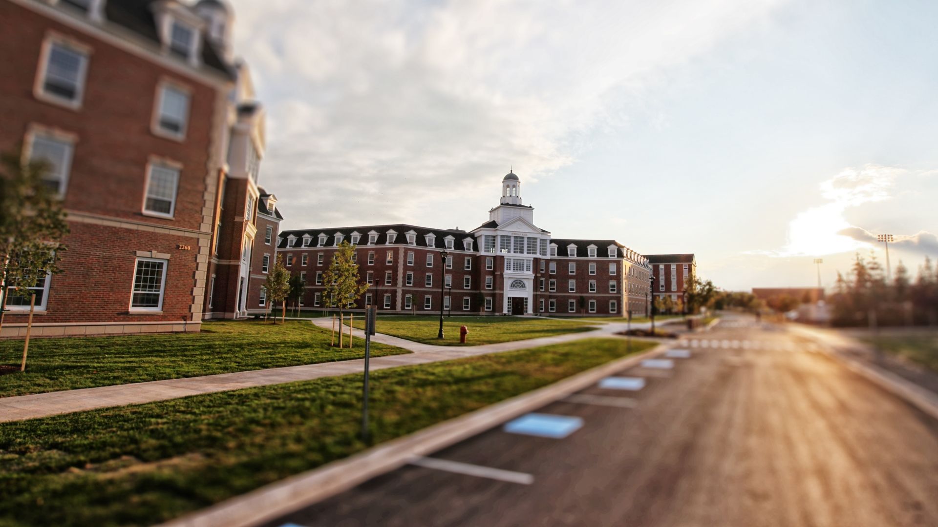Street view of O'Regan Hall during sunset on a summer day.
