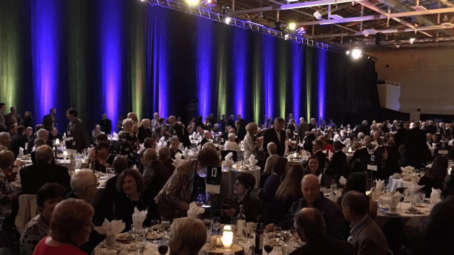A crowd of people in a formal event setting