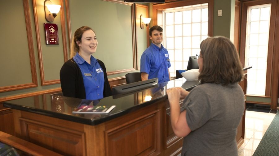 StFX Hotel Staff talking with customer