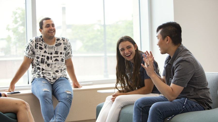 Students interacting on the first floor of Mulroney Hall