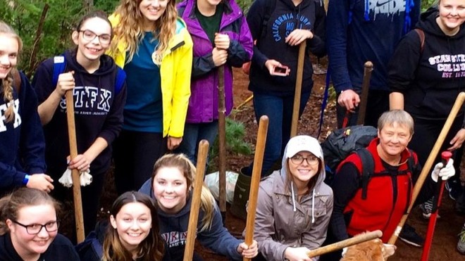 A class of students posing in the garden