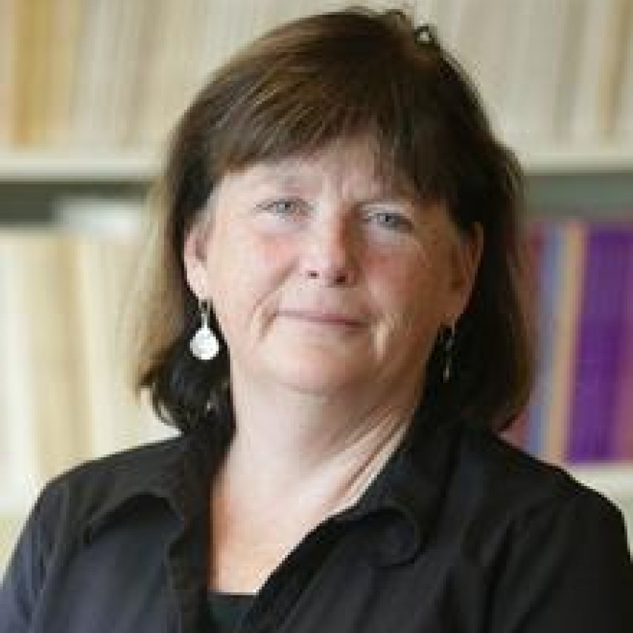 A person standing in front of a bookcase