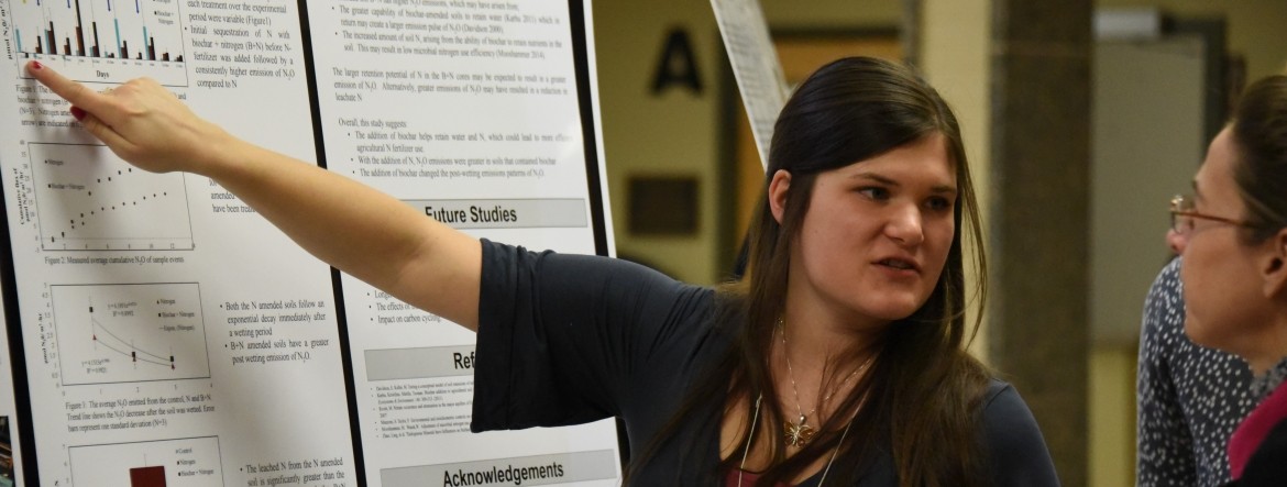 Banner Image Showing Program Graduate Presenting Research Findings