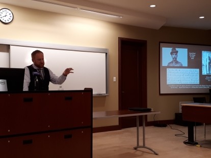 Picture of Dr. Peter Ludlow Presenting in a Talk