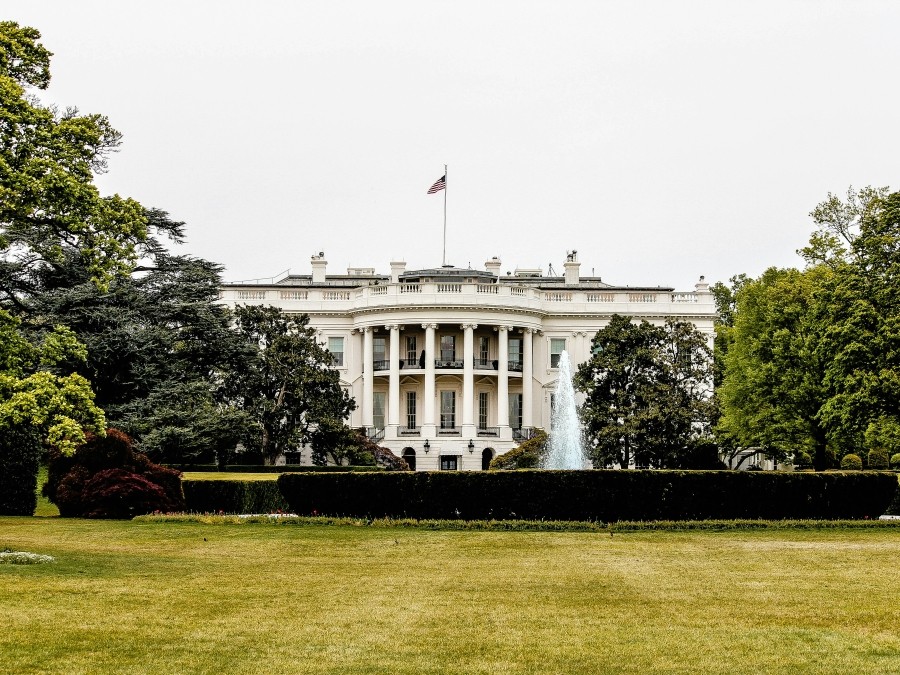 The US White House with an expanse of grass in front of it.