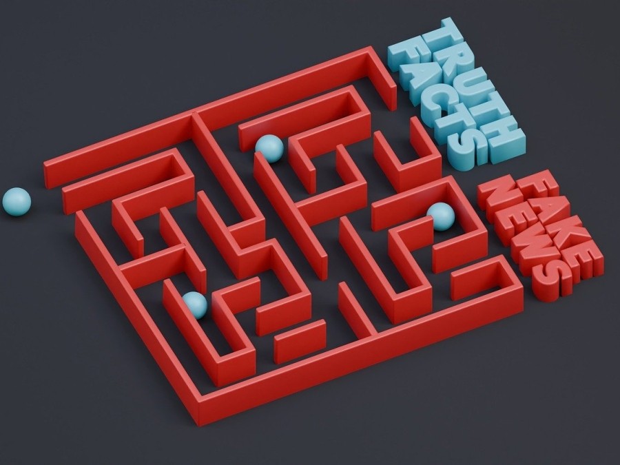 A bead maze with the labels "Truth Facts" and "Fake News" at openings to the maze